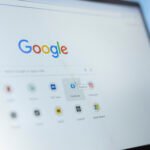 Bucharest, Romania - July 30th 2024 - Young man clicks on Facebook page bookmark on Google, looking at his search engine saved icons and selecting social media platform to stay informed.